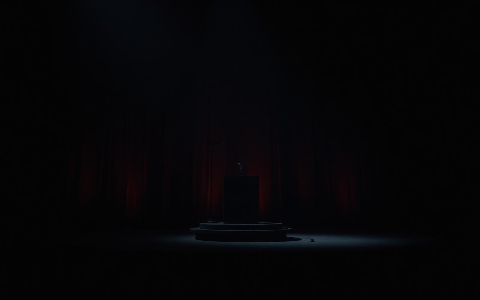 Dark stage with a single spotlight, representing Ma Zwane's award recognition